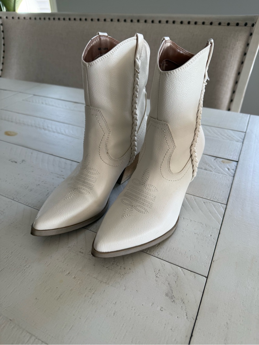 Woman’s  white boots goes beautifully with dresses or jeans
